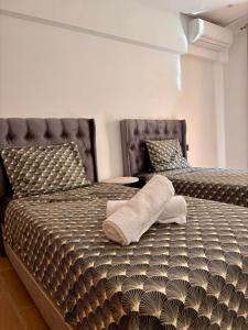 two beds in a room with two bedsskirts at Nice apartment in Marrakesh in Marrakesh +16 photos