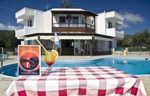 a drink on a table in front of a house at Albatross Studios in Kefalos