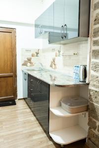 a kitchen with a sink and a counter top at Antique Hotel Baku in Baku +28 photos