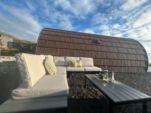 a white couch and a coffee table on a patio at Danu Resort in Castlerock