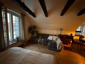 a bedroom with a bed and a couch and a piano at Kalmar City in Kalmar