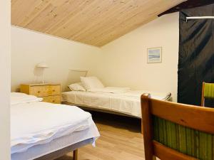 a bedroom with two beds and a wooden ceiling at Cozy 5 rooms apartment Landskrona city in Landskrona