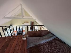 a bed sitting on a wooden floor in a room at The T Cottage in Othaya