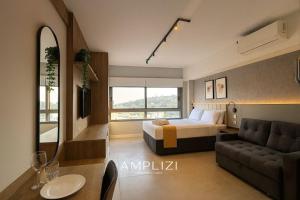 a hotel room with a bed and a couch at Linked Ampllizi in Porto Alegre +16 photos