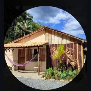 a small house with a purple rope around it at Canto do Sabiá PETAR Hospedagem in Iporanga +19 photos