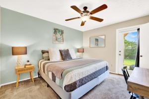 a bedroom with a bed and a ceiling fan at Two Spaces in One Main House and Guest House 25 Min to PCB in Panama City +78 photos