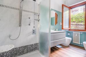 a bathroom with a shower and a sink and a toilet at Rapallo Charm in green in Rapallo
