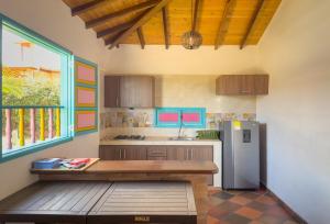 a kitchen with a counter and a refrigerator at Hacienda El Encanto in Los Santos