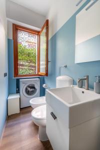 a bathroom with a sink and a washing machine at Rapallo Charm in green in Rapallo