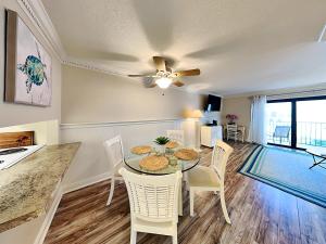 a kitchen and dining room with a table and chairs at Bent Palm 218 in Ormond Beach
