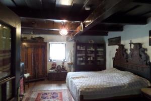 a bedroom with a large bed and a window at Natura Vendégház in Pázmánd