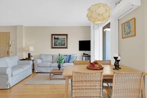 a living room with a table and a couch at Apartment in Calella de Palafrugell with a pool and parking in Calella de Palafrugell