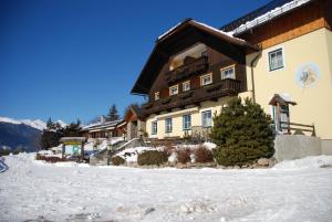 a large building with snow in front of it at Hotel Zum Granitzl in Mariapfarr