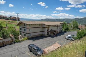 a building with cars parked in a parking lot at Ski In, Ski Out, Ski Slope Views, California King, Recently Renovated in Steamboat Springs +29 photos
