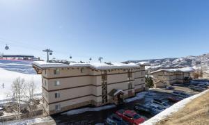 an apartment building with snow on the roof at Ski In, Ski Out, Ski Slope Views, California King, Recently Renovated in Steamboat Springs