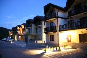 a building with lights on the side of a street at Apartment MonteBreza Spa in Kolašin