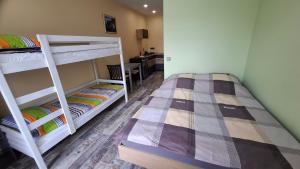 two bunk beds in a room with a kitchen at Edelweiss Vila Šventoji in Šventoji