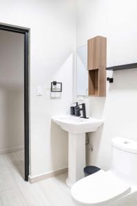 a bathroom with a sink and a toilet at Fully Renovated ADA-Accessible Beachside with Oceanview 1 Bedroom Unit 6 in Dorado +6 photos