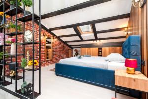 a bedroom with a bed and a brick wall at Apartman Rio in Rovinj
