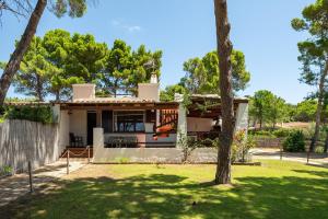 a house with a yard with a house at Elegante Villa a 30 m dalla bellissima spiaggia di Campulongu Villasimius in Villasimius