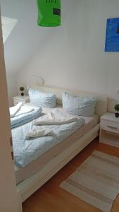 a bed with two pillows on it in a room at Kleine Möwe in Wilhelmshaven