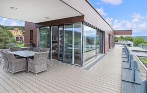 a deck with a table and chairs on a balcony at Ferienwohnung Pörtschach 110M² in Pörtschach am Wörthersee