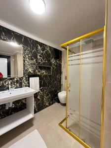 a bathroom with a shower and a sink and a toilet at Çakır Residence in Trabzon +40 photos