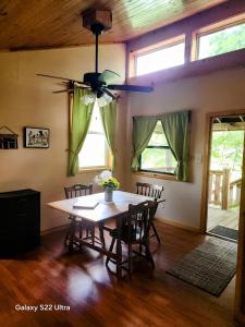 a dining room with a table and a ceiling fan at True West Campground in Jamestown