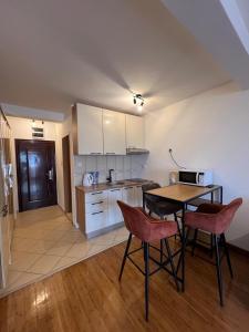 a kitchen with a table and chairs in a room at PriSMi PRZNO in Pržno