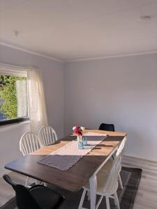 a dining room table with white chairs and a wooden table at House in Nordfjord, with 4 bedrooms in Nordfjordeid
