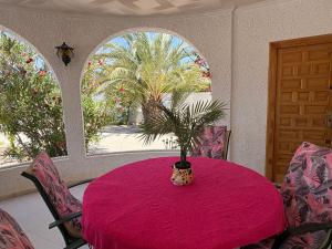 a dining room with a table with a plant on it at Ideal pool chalet WBR in La Mata
