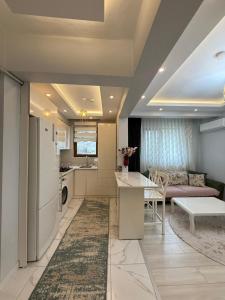 a kitchen and living room with a couch and a table at Çakır Residence in Trabzon
