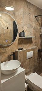 a bathroom with a sink and a mirror at Apartmani Žunić in Pag +62 photos