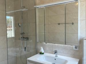 a bathroom with a sink and a shower with a mirror at Ideal pool chalet WBR in La Mata +13 photos