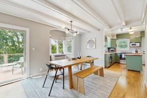 a kitchen and dining room with a wooden table and chairs at Balsam House in Baraboo