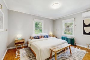 a bedroom with a large bed and two windows at Balsam House in Baraboo