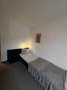Postel nebo postele na pokoji v ubytování Aparthotel Zur Linde - by Willms & Schömer eG