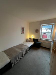 Postel nebo postele na pokoji v ubytování Aparthotel Zur Linde - by Willms & Schömer eG