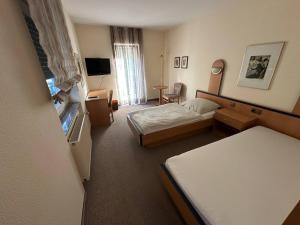 Postel nebo postele na pokoji v ubytování Aparthotel Zur Linde - by Willms & Schömer eG