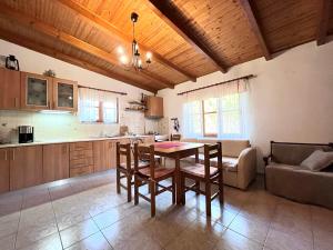 a kitchen and living room with a table and chairs at Lucky Farm House in Potamiá