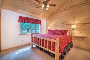 a bedroom with a bed in a log cabin at Game Room and Deck Pet-Friendly Camp Connell Cabin in Camp Connell