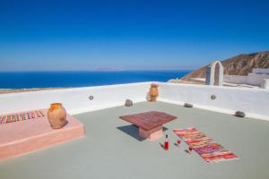 a room with a table and a view of the ocean at Skyline Villa in Pirgos