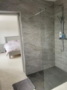 a bathroom with a shower with a glass door at Keeloges House 