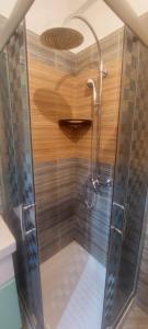 a shower with a glass door in a bathroom at Vento Apartments in Tirana