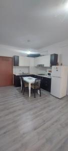 an empty kitchen with a table and two chairs at Vento Apartments in Tirana