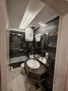 a bathroom with a sink and a shower at Aura Garden City Hotel in Cairo