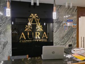 a banner for a caribbean city hotel with a laptop at Aura Garden City Hotel in Cairo