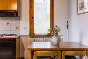 a kitchen with a table with a vase on it at Villa Sanziana in Menaggio