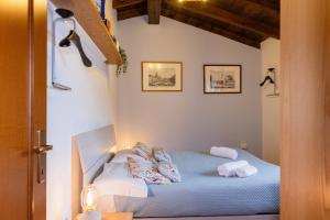 a bedroom with a blue bed with pillows on it at Villa Sanziana in Menaggio