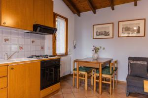 a kitchen with a table and a stove top oven at Villa Sanziana in Menaggio
